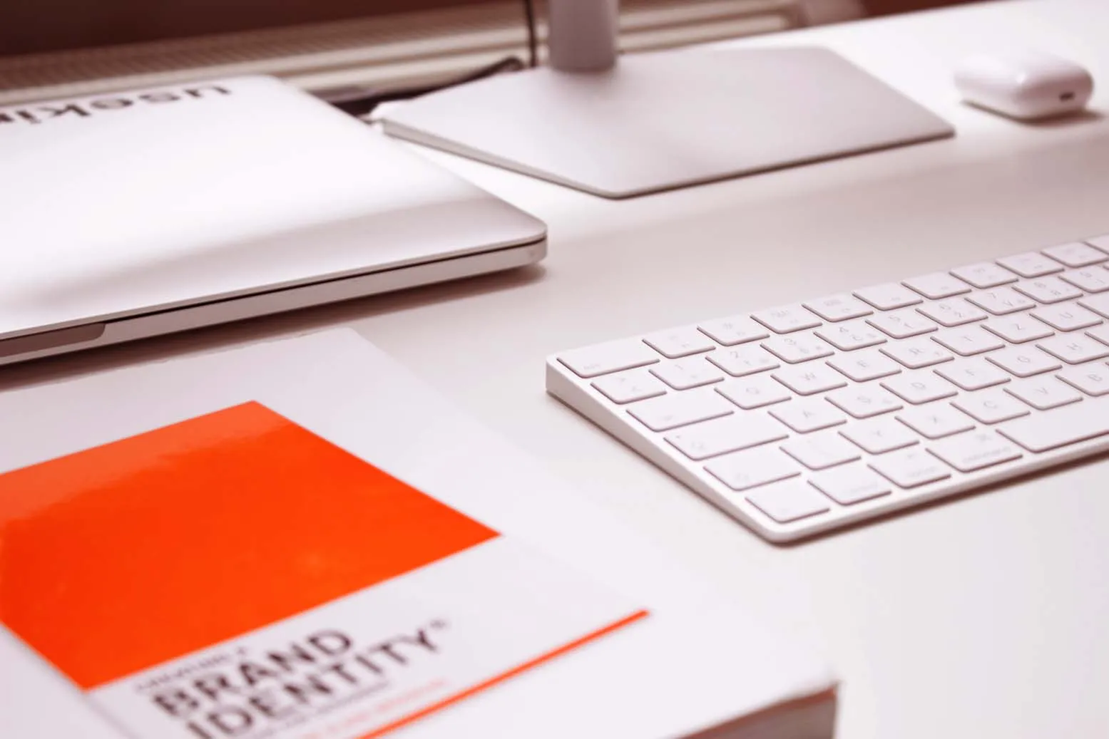 brand identity book and imac on a desk